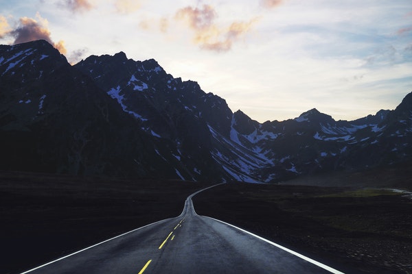 two-lane road headed into the mountains